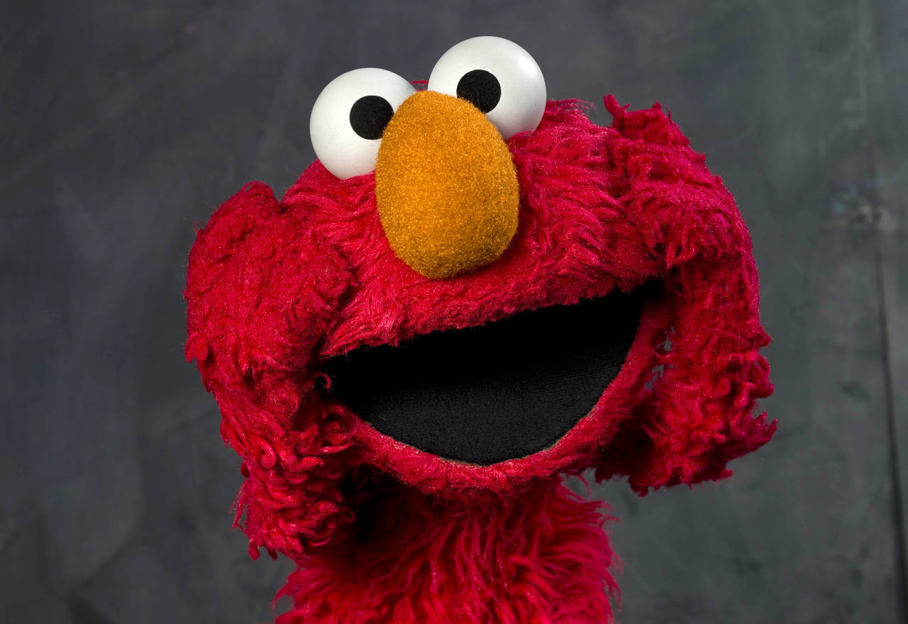 FILE - This Jan. 24, 2011, photo shows "Sesame Street" muppet Elmo posing for a portrait with the a...