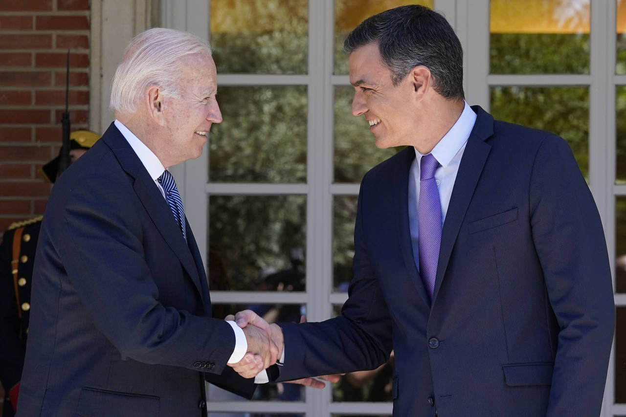 President Joe Biden and Spain's Prime Minister Pedro Sánchez shake hands as they meet at the Palac...