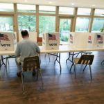 
              FILE - A voter sits alone at a poll kiosk to cast his vote at a Mississippi Second Congressional District Primary election precinct, June 7, 2022, in Jackson, Miss. More than 1 million voters across 43 states have switched to the Republican Party over the last year, according to voter registration data analyzed by The Associated Press. (AP Photo/Rogelio V. Solis, File)
            