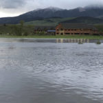 
              Flooding from the Yellowstone River is seen in front of Livingston HealthCare's hospital in Livingston, Montana, on Monday evening, June 13, 2022. Livingston HealthCare evacuated its patients and staff on Monday because water over the driveway made access to the building unsafe. While an urgent care clinic remained open, emergency patients were being diverted to other facilities. (Dwight Harriman/Livingston Enterprise via AP)
            