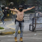 
              Demonstrators clash with police during protests against the government of President Guillermo Lasso and rising fuel prices in Quito, Ecuador, Tuesday, June 21, 2022. Ecuador's defense minister warned Tuesday that the country's democracy was at risk as demonstrations turned increasingly violent in the capital. (AP Photo/Dolores Ochoa)
            
