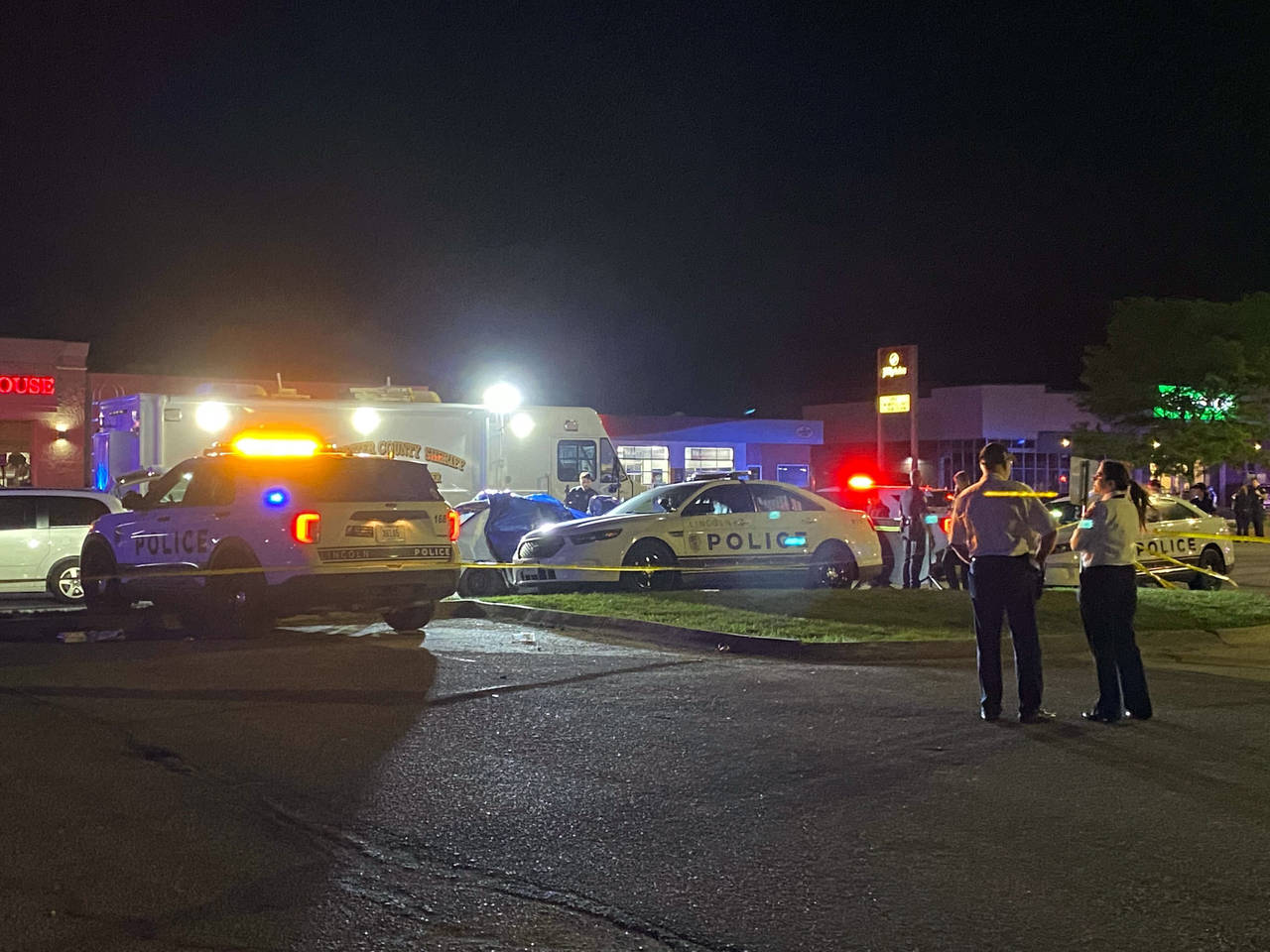CORRECTS TO CAR CRASH, NOT A FATAL SHOOTING - Emergency personnel gather at the scene of a crash th...