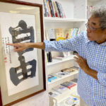 
              Lam Wing-Kee, a Hong Kong bookstore owner who fled to Taiwan in 2019, gestures at a calligraphy with the words "Freedom" during an interview inside his bookstore in Taipei, Taiwan on June 8, 2022. Coming to Taiwan was a logical step for Lam, a Hong Kong bookstore owner who was held by police in China for five months for selling sensitive books about the Communist Party. An island just 400 miles from Hong Kong, Taiwan is close not just geographically but also linguistically and culturally. (AP Photo/Johnson Lai)
            