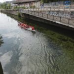 
              Boys paddle on low water levels of the Naviglio Grande river channel in Milan, Italy, Thursday, June 23, 2022. The worst drought Italy has faced in 70 years is thirsting paddy fields in the river Po valley and jeopardizing the harvest of the premium rice used for risotto. (AP Photo/Luca Bruno)
            