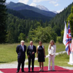
              British Prime Minister Boris Johnson, left, and his wife Carrie Johnson, right, talk with German Chancellor Olaf Scholz and Britta Ernst, Minister of Education, Youth, and the Federal State of Bradenburg, at the G7 Summit in Elmau, Germany, Sunday, June 26, 2022, during an arrival ceremony. (AP Photo/Susan Walsh, Pool)
            