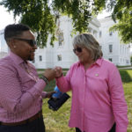 
              Nat McKeller Crosby, left, greets Lisa Turner in front of the State Capitol, Wednesday June 8, 2022, in Richmond, Va. The pair decided not to attend a reception at the Capitol given by Republican Virginia Gov. Glenn Youngkin for Pride Month. (AP Photo/Steve Helber)
            