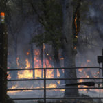 
              Flames from the Rices Fire burn near a home along Troost Trail Tuesday, June 28, 2022, in rural North San Juan, Calif. (Elias Funez/The Union via AP)
            