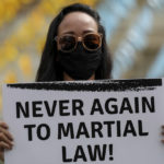 
              An activist carries a placard against the inauguration ceremony of President-elect Ferdinand "Bongbong" Marcos Jr. during a protest in Manila, Philippines on Thursday, June 30, 2022. Ferdinand Marcos Jr., the namesake son of an ousted dictator, was sworn in as Philippine president Thursday in one of history's greatest political comebacks but which opponents say was pulled off by whitewashing his family's image. (AP Photo/Basilio Sepe)
            