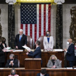 
              FILE - Vice President Mike Pence, left, and Speaker of the House Nancy Pelosi, D-Calif., return to the House chamber after midnight, Jan. 7, 2021, to finish the work of the Electoral College after a mob loyal to President Donald Trump stormed the Capitol in Washington and disrupted the process.  (AP Photo/J. Scott Applewhite, File)
            