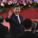 
              China's President Xi Jinping waves following his speech after a ceremony to inaugurate the city's new government in Hong Kong Friday, July 1, 2022, on the 25th anniversary of the city's handover from Britain to China. (Selim Chtayti/Pool Photo via AP)
            