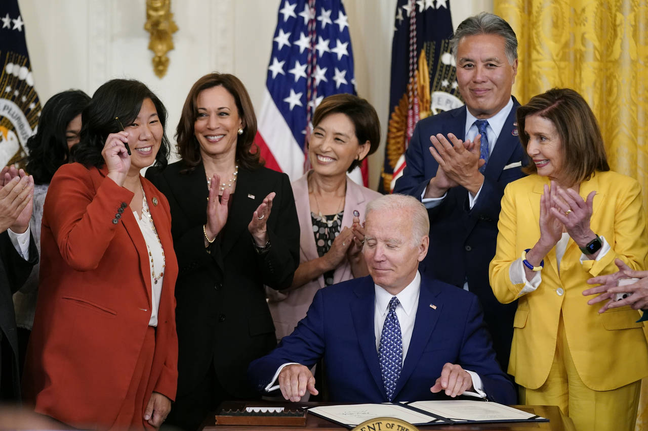 Rep. Grace Meng, D-N.Y., holds up a pen given to her by President Joe Biden during a bill signing c...