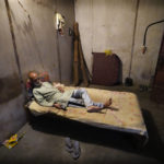 
              A Kashmiri minority Hindu Prabuman Krishan Tikoo, 60, who fled Kashmir in the 1990s, rests in his single room accommodation at the Purkhoo migrant camp where he lives alone on the outskirts of Jammu, India, June 11, 2022. Kashmir's minority Hindus, who are locally known as Pandits, have long fretted over their place in the disputed region. Most of an estimated 200,000 of them fled Kashmir in the 1990s when an armed rebellion against Indian rule began. (AP Photo/Channi Anand)
            