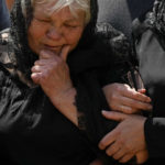 
              The mother of Army Col. Oleksander Makhachek cries during his funeral in Zhytomyr, Ukraine, Friday, June 3, 2022. According to combat comrades Makhachek was killed fighting Russian forces when a shell landed in his position on May 30. (AP Photo/Natacha Pisarenko)
            