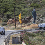 
              CORRECTS TO SAY CALLED TO RESUME INDIRECT TALKS NOT RESUMED TALKS - U.N. peacekeeping vehicles pass a Hezbollah flag and a statue of the late Iranian General Qassem Soleimani, as they patrol on a road along the Lebanese-Israeli border town of Naqoura, while Lebanon and Israel are being called to resume indirect talks over their disputed maritime border with U.S. mediation, south Lebanon, Monday, June 6, 2022. The Lebanese government invited on Monday a U.S. envoy mediating between Lebanon and Israel over their disputed maritime border to return to Beirut as soon as possible to work out an agreement amid rising tensions along the border. (AP Photo/Mohammed Zaatari)
            