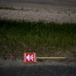 
              A poster warning about mines lies beside a road in Lypivka, on the outskirts of Kyiv, Ukraine, Tuesday, June 14, 2022. Russia’s invasion of Ukraine is spreading a deadly litter of mines, bombs and other explosive devices that will endanger civilian lives and limbs long after the fighting stops. (AP Photo/Natacha Pisarenko)
            