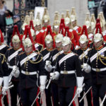 
              Members of the Household Cavalry march ahead, during the Platinum Jubilee Pageant outside Buckingham Palace in London, Sunday June 5, 2022, on the last of four days of celebrations to mark the Platinum Jubilee. The pageant will be a carnival procession up The Mall featuring giant puppets and celebrities that will depict key moments from Queen Elizabeth II’s seven decades on the throne. (Chris Jackson/Pool Photo via AP)
            