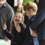 
              Britain's Princess Charlotte laughs as she conducts a band next to her brother, Prince George,  during their visit to Cardiff Castle in Cardiff, Wales, Saturday, June 4 2022, as members of the Royal Family visit the nations of the UK to celebrate Queen Elizabeth II's Platinum Jubilee. (Ashley Crowden/PA via AP)
            