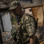 
              Commander of an artillery unit of the Ukrainian army, Mykhailo Strebizh, center, inside a destroyed house due to shelling in a village near the frontline in the Donetsk oblast region, eastern Ukraine, Thursday, June 2, 2022. (AP Photo/Bernat Armangue)
            