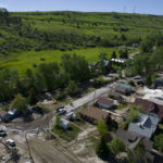 
              In this aerial image taken with a drone, sandbags and mud covered roads are left behind after floodwaters from Rock Creek receded, Wednesday, June 15, 2022, in Red Lodge, Mont. Historic floodwaters that raged through Yellowstone National Park may have permanently altered the course of a popular fishing river and left the sweeping landscape forever changed.  (AP Photo/Brittany Peterson)
            