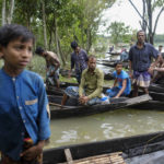 
              Flood affected people wait to receive relief material in Sylhet, Bangladesh, Wednesday, June 22, 2022. (AP Photo/Mahmud Hossain Opu)
            