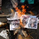 
              Indian Muslims burn an effigy with portraits of Nupur Sharma, the spokesperson of governing Hindu nationalist party and former lawmaker Naveen Jindal, as they react to the derogatory references to Islam and the Prophet Muhammad in Kolkata, India, Friday, June 10, 2022. Thousands of Muslims emerging from mosques after Friday prayers held street protests and hurled rocks at the police in some Indian towns and cities over remarks by two officials from India’s ruling party that were derogatory to the Prophet Muhammad.  (AP Photo/Bikas Das)
            