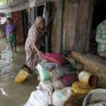 
              People inspect the damaged belongings in their homes as flood water levels recede slowly in Sylhet, Bangladesh, Wednesday, June 22, 2022. (AP Photo/Mahmud Hossain Opu)
            