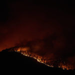 
              Trees burn as flames and smoke engulf the top of a hill in a forest fire in Artazu, northern Spain in the early hours of Sunday, June 19, 2022. Firefighters in Spain are struggling to contain wildfires in several parts of the country suffering an unusual heat wave for this time of the year. (AP Photo/Miguel Oses)
            