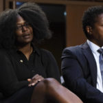 
              Zeneta Everhart, whose son Zaire Goodman, 20, was shot in the neck during the Buffalo Tops supermarket mass shooting and survived, left, and Raymond Whitfield whose mother, Ruth Whitfield, was killed during the shooting, react as Sen. Ted Cruz, R-Texas, speaks during a Senate Judiciary Committee hearing on domestic terrorism, Tuesday, June 7, 2022, on Capitol Hill in Washington. (AP Photo/Jacquelyn Martin)
            
