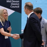 
              CORRECTS DATE - The Liberal Democrats' by-election candidate Richard Foord, right, shakes hands with the Conservative by-election candidate Helen Hurford, left, at the Lords Meadow Leisure Centre, in Crediton, Devon, England, after the result of the Tiverton and Honiton by-election, which was triggered by the resignation of MP Neil Parish for watching pornography in the Commons, Friday, June 24, 2022.(Andrew Matthews/PA via AP)
            
