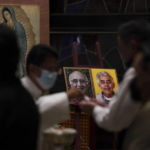 
              Worshipers partake of communion during a Mass to mourn the death of Jesuit priests Javier Campos Morales and Joaquin Cesar Mora Salazar, at a church in Mexico City, Tuesday, June 21, 2022. The two elderly priests were killed inside a church where a man pursued by gunmen apparently sought refuge in a remote mountainous area of northern Mexico, the religious order's Mexican branch announced Tuesday. (AP Photo/Fernando Llano)
            
