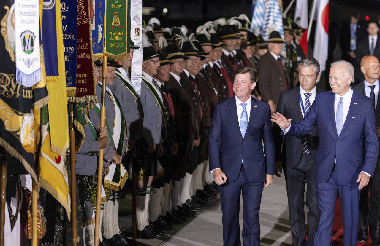 U.S. President Joe Biden, right, waves as he walks past Bavarian mountain riflemen and traditional ...