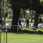 
              Officers investigate after shots were fired in or near Graceland Cemetery in Racine, Wis., on Thursday, June 2, 2022. Officials say there were multiple victims in the shooting at the cemetery located 30 miles south of Milwaukee. Witnesses said they heard up to 20 to 30 shots. It was not immediately known if there were any fatalities, or if any suspects were in custody.(Alex Rodriguez/The Journal Times via AP)
            