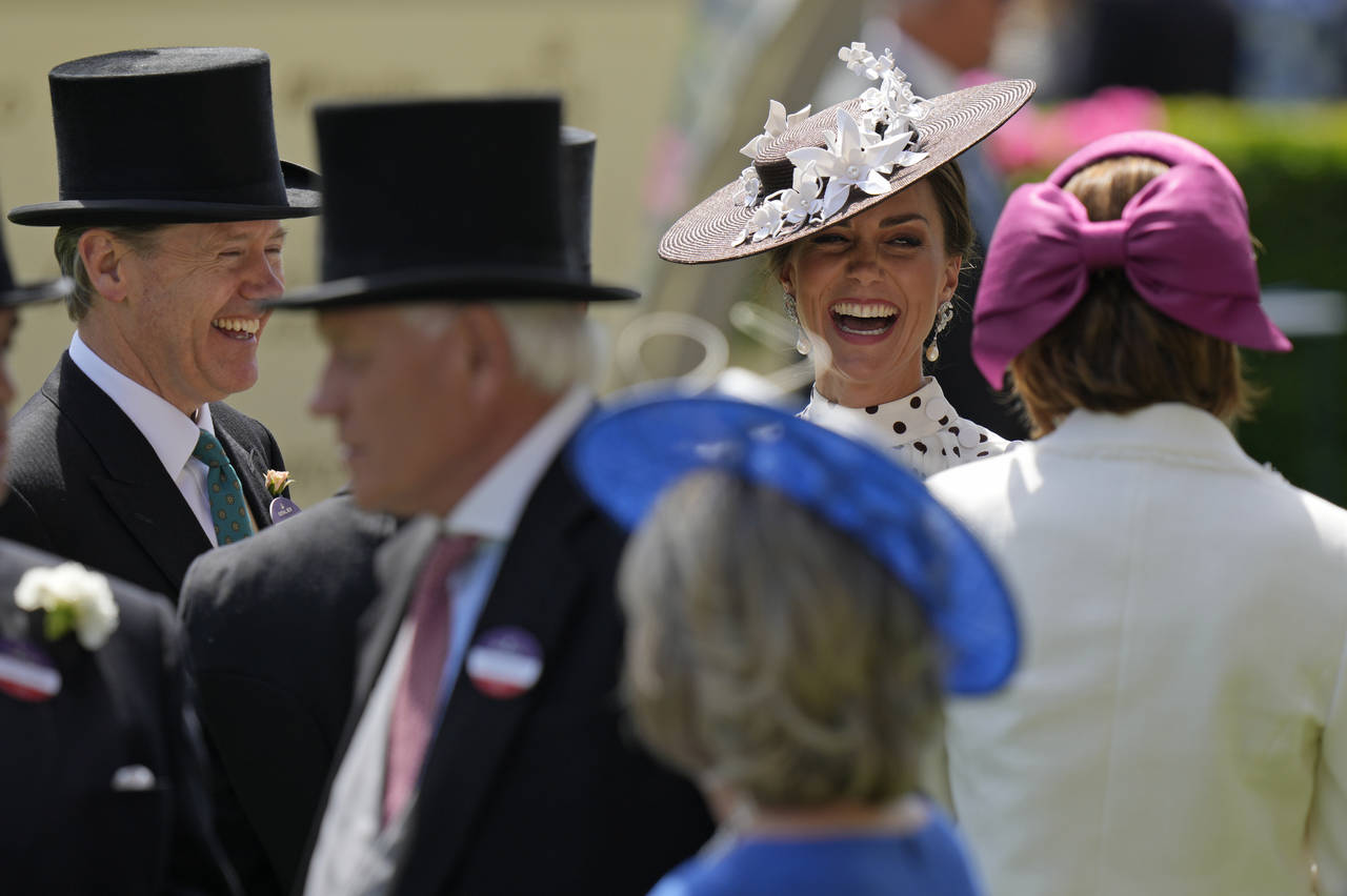 Kate, Duchess of Cambridge, second right, laughs as she stands in the paddock on the fourth day of ...