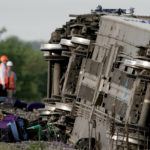 
              Workers inspect the scene of an Amtrak train which derailed after striking a dump truck Monday, June 27, 2022, near Mendon, Mo. (AP Photo/Charlie Riedel)
            