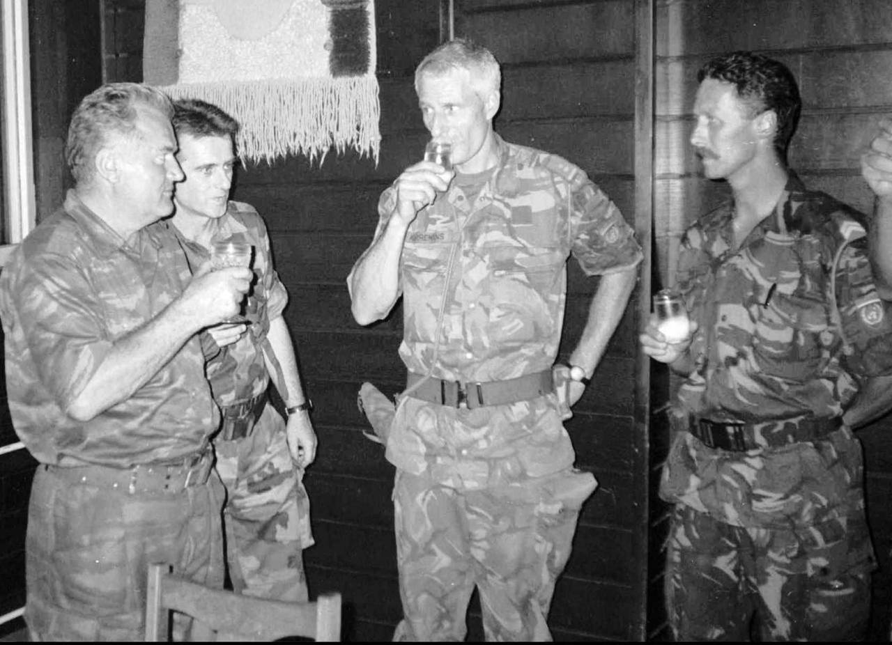FILE - Bosnian Serb army Commander General Ratko Mladic, left, drinks with Dutch U.N Commander Tom ...