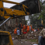 
              Rescuers work at the site of a four-story residential building that collapsed in Mumbai, India, Tuesday, June 28, 2022. At least three people died and more were injured after the building collapsed late Monday night. (AP Photo/Rafiq Maqbool)
            