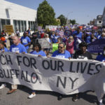 
              Protesters march down Jefferson Avenue  at the site of the Tops massacre during a March for Our Lives rally in support of gun control, Saturday, June 11, 2022, in Buffalo, N.Y. (Derek Gee/The Buffalo News via AP)
            