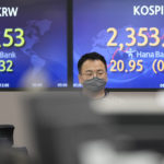 
              A currency trader walks by the screens showing the Korea Composite Stock Price Index (KOSPI), right, and the foreign exchange rate at a foreign exchange dealing room in Seoul, South Korea, Friday, July 1, 2022. Asian benchmarks were mostly lower on Friday, echoing a decline on Wall Street, after a quarterly report by Japan’s central bank rekindled worries about the world’s third largest economy. (AP Photo/Lee Jin-man)
            