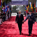 
              His Excellency Enrique Reina, Minister of Foreign Affairs and International Cooperation of the Republic of Honduras, left, walks on on the red carpet prior to the opening ceremony of the Summit of the Americas, Wednesday, June 8, 2022, in Los Angeles. (AP Photo/Marcio Jose Sanchez)
            