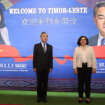 
              Chinese Foreign Minister Wang Yi, left, stands on the stage with his East Timorese counterpart Adaljiza Magno as they pose for photographers during their meeting in Dili, East Timor, Friday, June 3, 2022. (AP Photo/Lorenio Do Rosario Pereira)
            