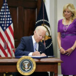 
              President Joe Biden signs into law S. 2938, the Bipartisan Safer Communities Act gun safety bill, in the Roosevelt Room of the White House in Washington, Saturday, June 25, 2022. First lady Jill Biden looks on at right. (AP Photo/Pablo Martinez Monsivais)
            