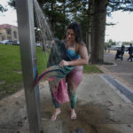 
              Lauren Metzler, founder of Sydney Mermaids, washes her tail after a swim at Manly Cove Beach in Sydney, Australia, Thursday, May 26, 2022. Across the world, people are increasingly embracing the subculture of “mermaiding.” At its simplest, these are humans of all genders, shapes and backgrounds who enjoy dressing up as mermaids. (AP Photo/Mark Baker)
            
