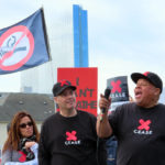 
              FILE - Borgata casino dealer Lamont White, right, speaks at a rally in Atlantic City, N.J., on April 12, 2022, calling on New Jersey's state Legislature to pass a bill that would ban smoking in casinos. Onstage with him are fellow Borgata dealers Nicole Vitola, left, and Pete Naccarelli, center. A report issued Friday, June 17, 2022, by a Las Vegas gambling research company suggested that ending smoking in casinos will not result in significant financial harm to the businesses. (AP Photo/Wayne Parry, File)
            