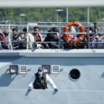 
              A group of people thought to be migrants are brought in to Dover by Border Force, following a small boat incident in the Channel, in Kent, England,  Tuesday June 14, 2022. (Andrew Matthews/PA via AP)
            