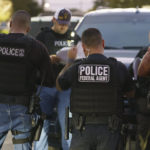 
              U.S. Immigration and Customs Enforcement agents gather before a raid to arrest immigrants considered a threat to public safety and national security during an early morning raid in Compton, Calif., Monday, June 6, 2022. This weekend, the Biden administration said it would suspend an order prioritizing the arrest and deportation of immigrants considered a threat to public safety and national security in order to comply with a ruling earlier in June 2022 from a Texas judge. Many otherwise law-abiding immigrants living here illegally will now be afraid to leave their homes out of concern they'll be detained. (AP Photo/Damian Dovarganes)
            