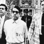 
              FILE - Mass murderer James Ruppert, center, is taken back to jail after his arraignment in Hamilton, Ohio, on eleven counts of aggravated murder, April 8, 1975. Ruppert, 88, who was serving a life sentence for the shooting deaths of 11 family members — including eight children — died Saturday, June 4, 2022, at the prison system’s Franklin Medical Center in Columbus. (AP Photo/Brian Horton, File)
            