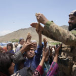 
              Afghans receive aid at a camp after an earthquake in Gayan district in Paktika province, Afghanistan, Sunday, June 26, 2022. A powerful earthquake struck a rugged, mountainous region of eastern Afghanistan early Wednesday, flattening stone and mud-brick homes in the country's deadliest quake in two decades, the state-run news agency reported. (AP Photo/Ebrahim Nooroozi)
            