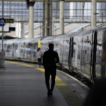 
              A man walks to board a train inside a much quieter than normal Waterloo railway station, in London, during a strike held by railway workers, Saturday, June 25, 2022. Train stations are all but deserted across Britain on the third day of a national strike that snarled the weekend plans of millions. Train companies said only a fifth of passenger services would run on Saturday. (AP Photo/Matt Dunham)
            