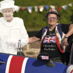 
              Royalist Anita Atkinson, who has collected more than 12,000 items of memorabilia on her way to a tea party in Durham, England, Thursday, June 2, 2022 on the first of four days of celebrations to mark the Platinum Jubilee. The events over a long holiday weekend in the U.K. are meant to celebrate the monarch’s 70 years of service.  (Owen Humphreys/PA via AP)
            