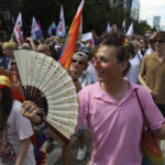 
              People take part in the 'Warsaw and Kyiv Pride' marching for freedom in Warsaw, Poland, Saturday, June 25, 2022. Due to Russia's full-scale war against Ukraine the 10th anniversary of the equality march in Kyiv can't take place in the usual format in the Ukrainian capital. The event joined Warsaw's yearly equality parade, the largest gay pride event in central Europe, using it as a platform to keep international attention focused on the Ukrainian struggle for freedom. (AP Photo/Michal Dyjuk)
            